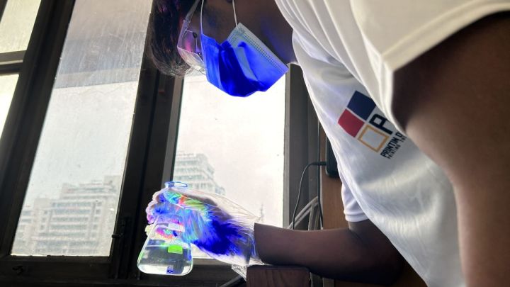 Lab-Technician-studying-chemical-in-flask